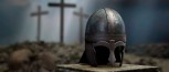 Roman centurion helmet in front of three crosses