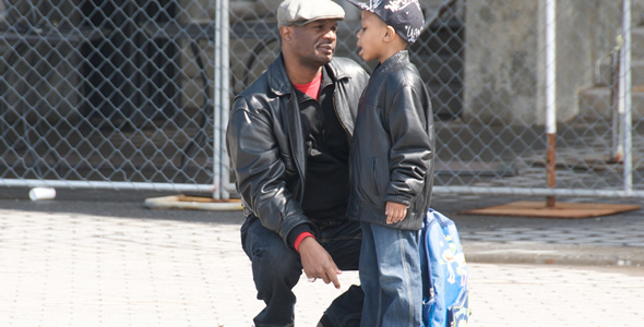 A father talking with his son before school